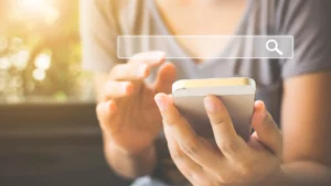 Female hands using a phone to search online